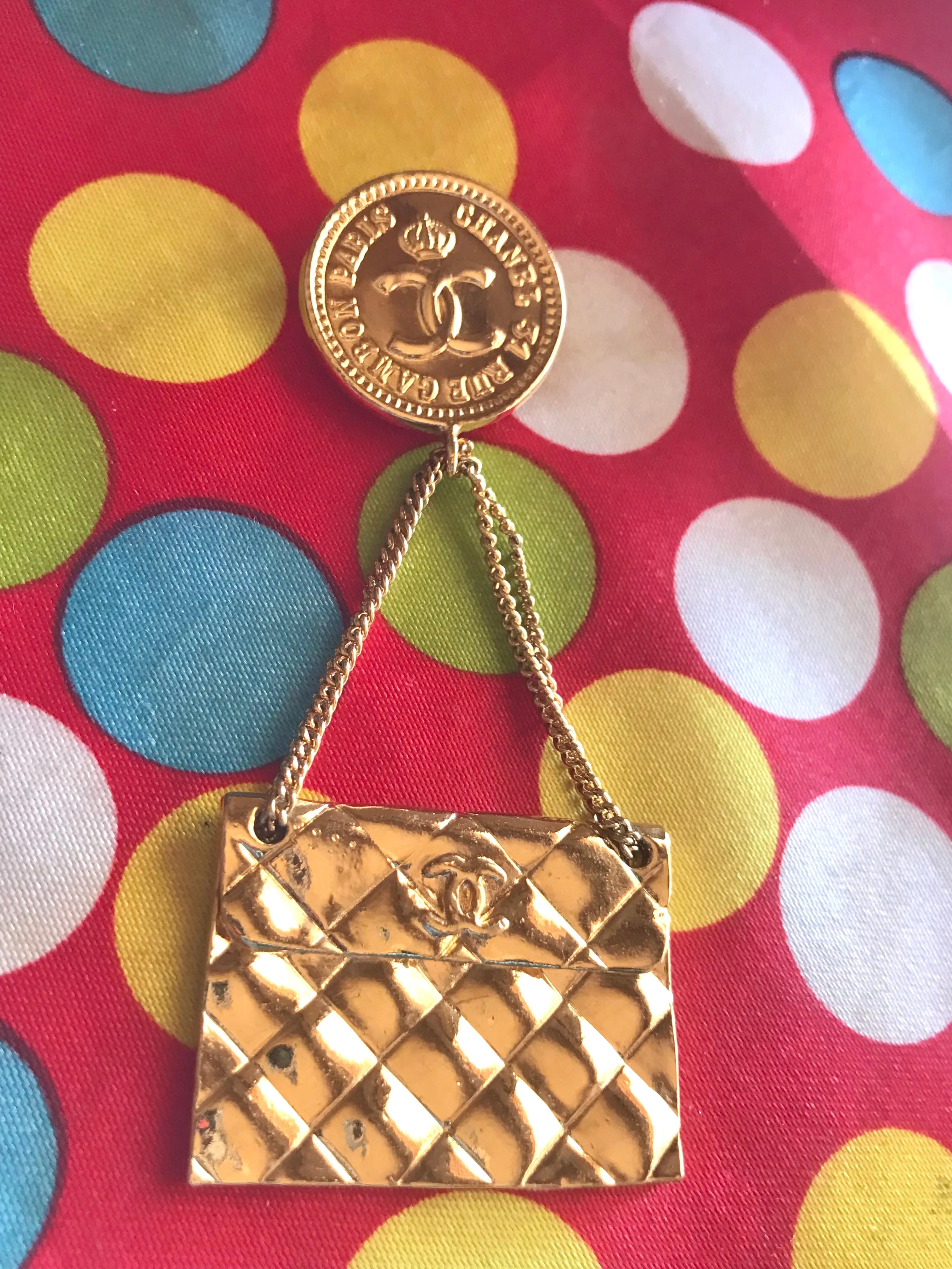 Vintage CHANEL Gold tone brooch with 2.55 classic purse and CC charms. Chic dangling brooch