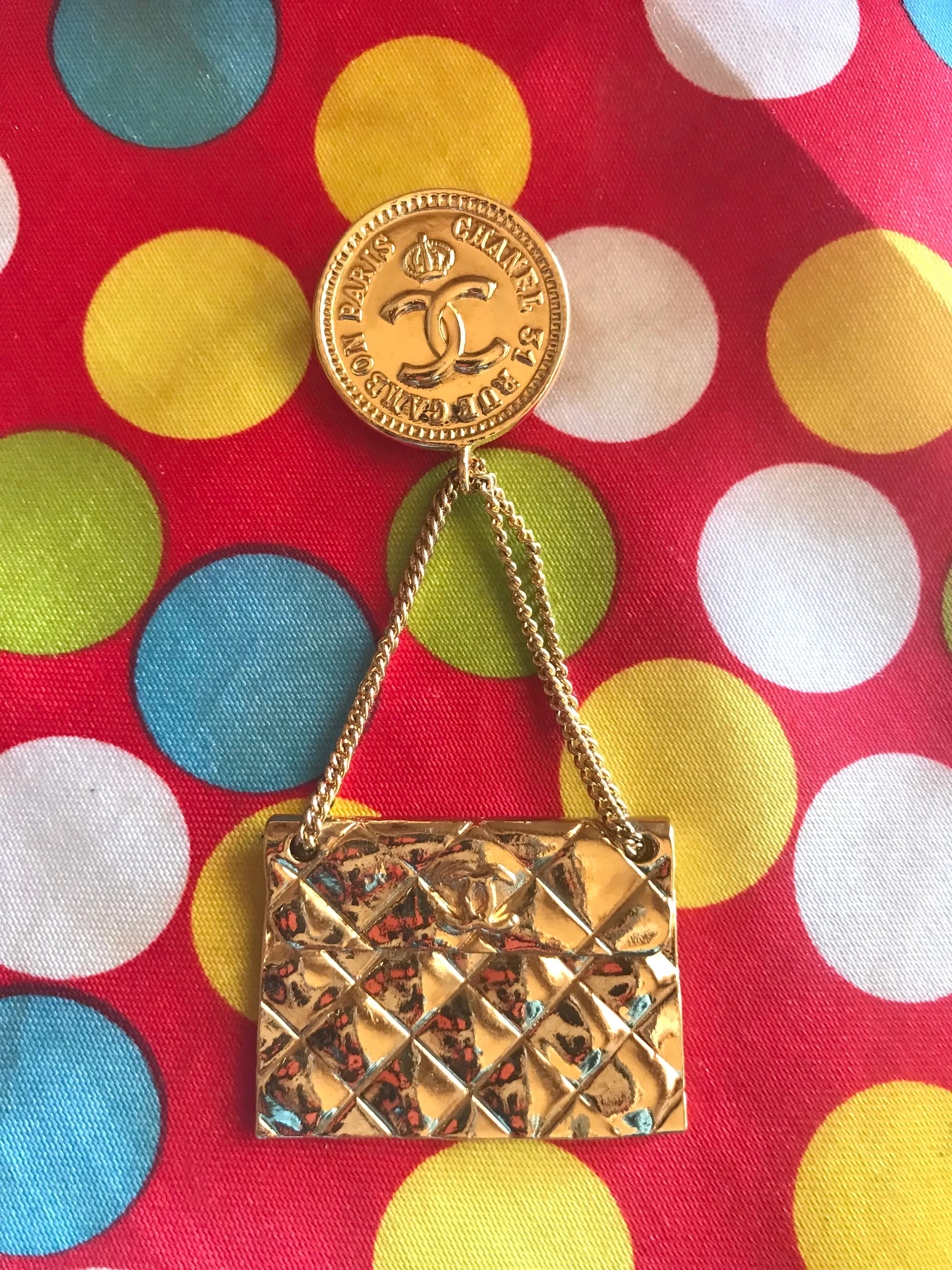 Vintage CHANEL Gold tone brooch with 2.55 classic purse and CC charms. Chic dangling brooch