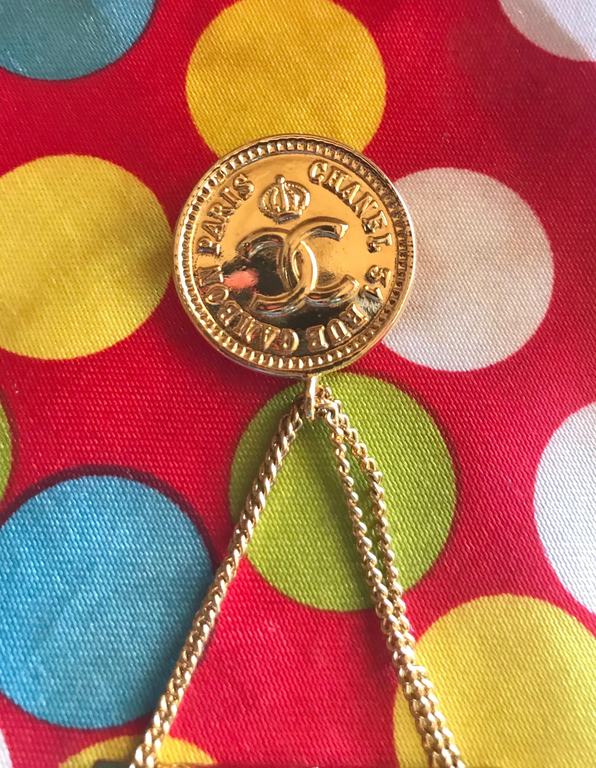 Vintage CHANEL Gold tone brooch with 2.55 classic purse and CC charms. Chic dangling brooch